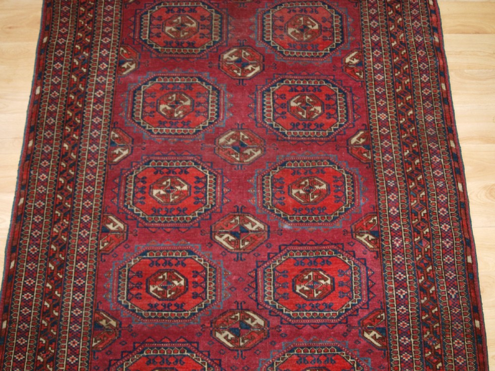 ANTIQUE TEKKE TURKMEN RUG WITH SALOR GULS, COCHINEAL COLOUR, CIRCA 1890. View VI