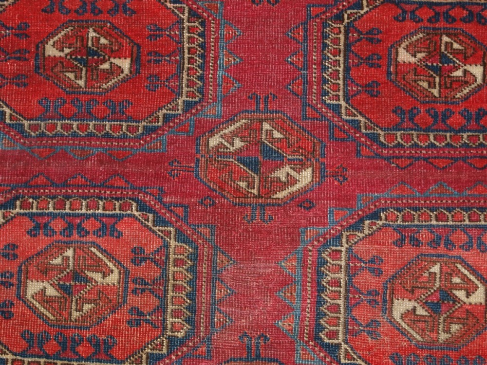 ANTIQUE TEKKE TURKMEN RUG WITH SALOR GULS, COCHINEAL COLOUR, CIRCA 1890. View VIII