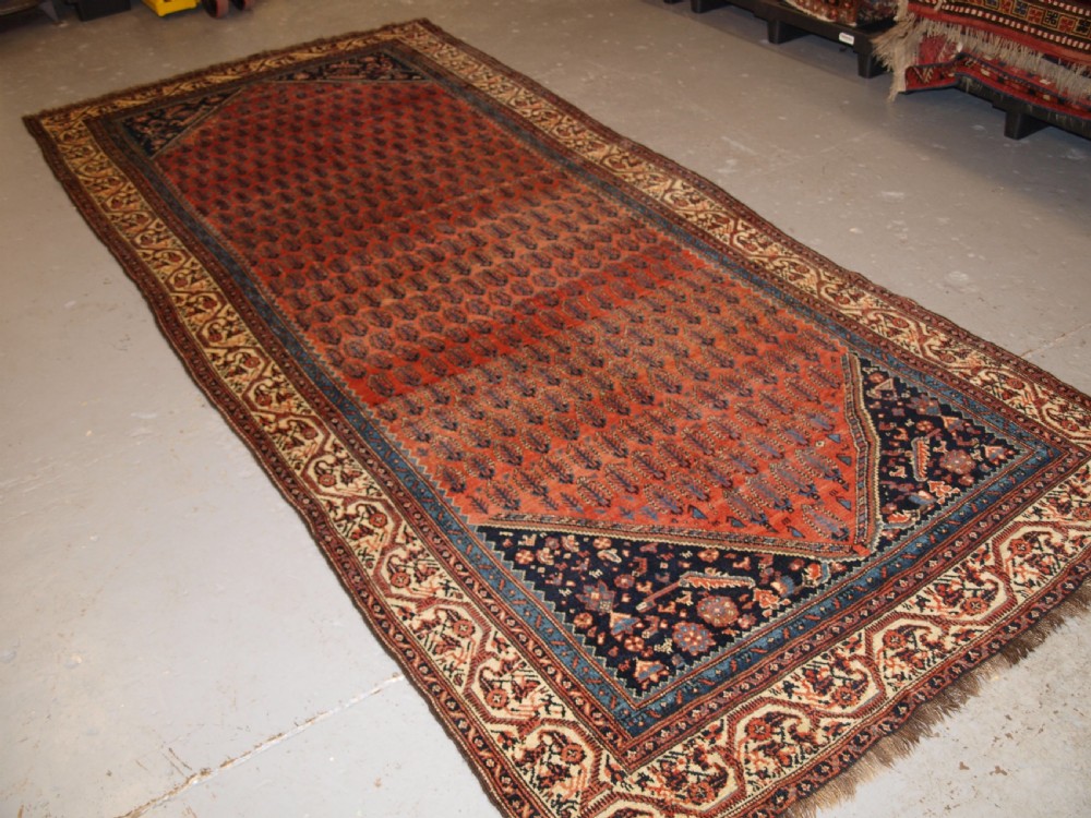 ANTIQUE SARABENT VILLAGE KELLEH LONG RUG WITH SHRUB DESIGN, CIRCA 1900.