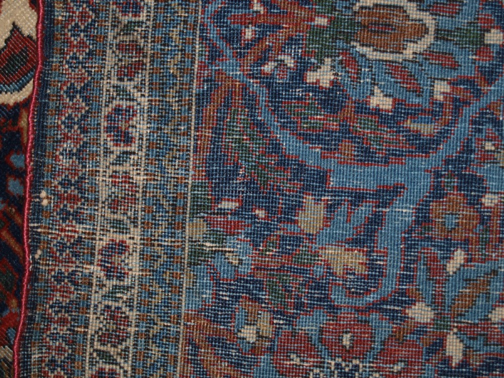 A hand-knotted Persian Kork Kashan wool rug featuring a central medallion with intricate floral motifs in navy blue, red, and cream. View XII