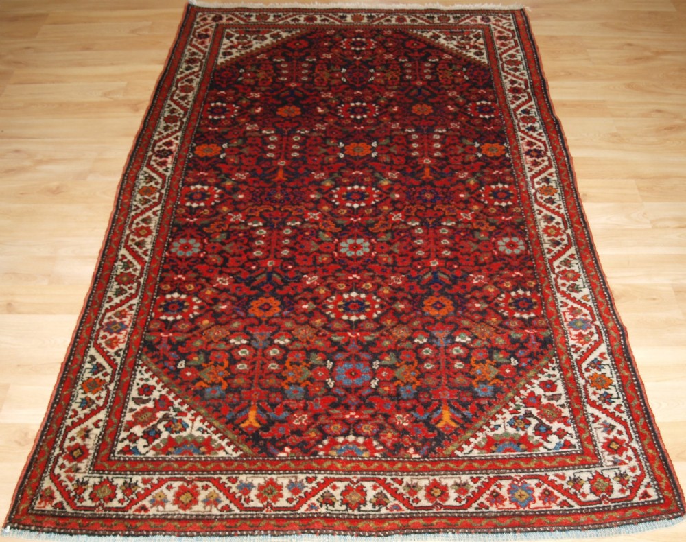 ANTIQUE MALAYER VILLAGE RUG , FLORAL SHRUB DESIGN, CIRCA 1920.