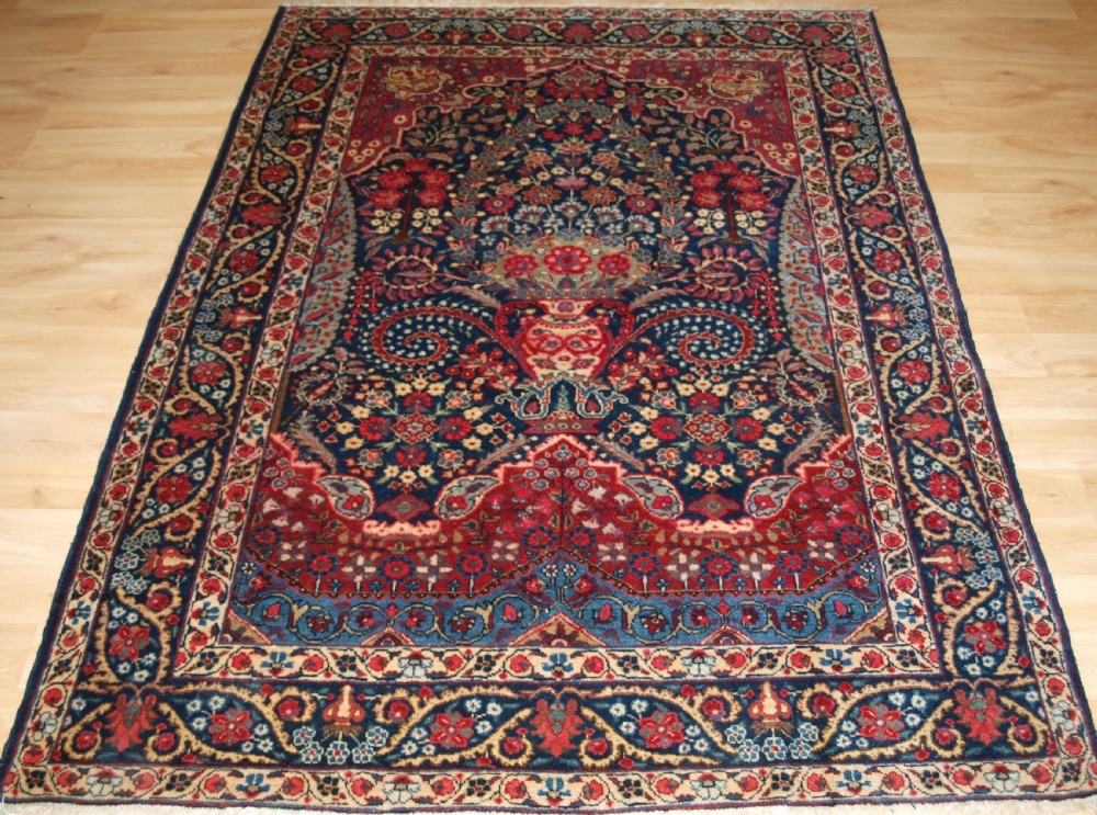 ANTIQUE TABRIZ RUG OF FLORAL VASE PRAYER DESIGN, ONE OF A PAIR, CIRCA 1920.