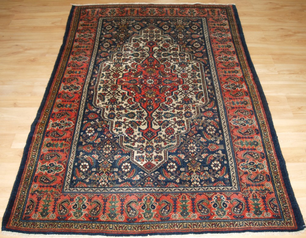 ANTIQUE MALAYER VILLAGE RUG, SOFT RED BORDER, CIRCA 1920.