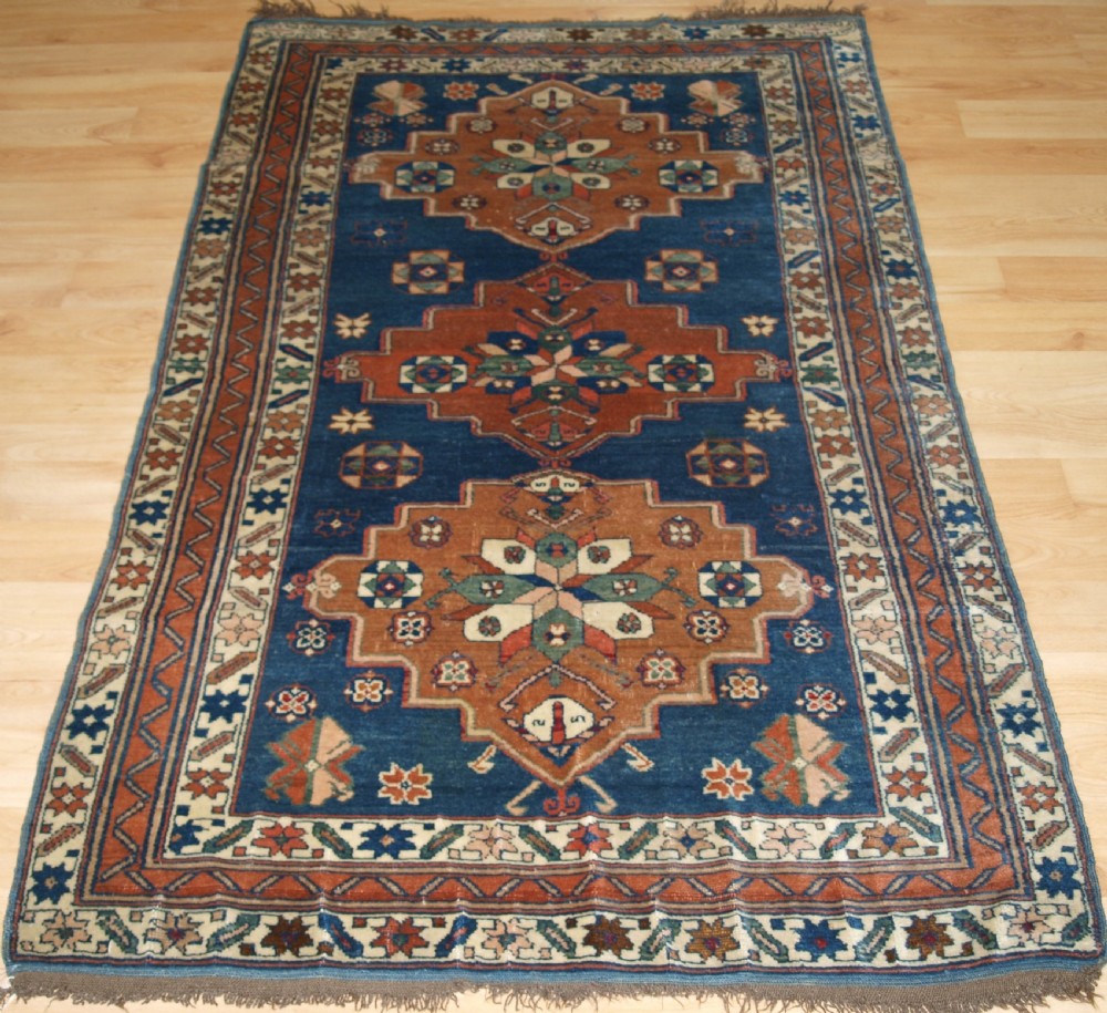 ANTIQUE CAUCASIAN DERBENT TRIPLE MEDALLION RUG, CIRCA 1900.