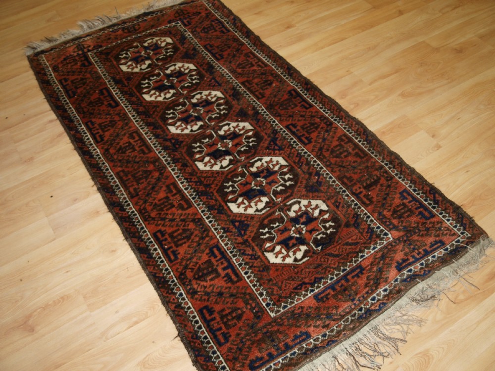 ANTIQUE MAHDAD KHANI BALUCH RUG, LARGE TURKMEN GULS, CIRCA 1900. View II