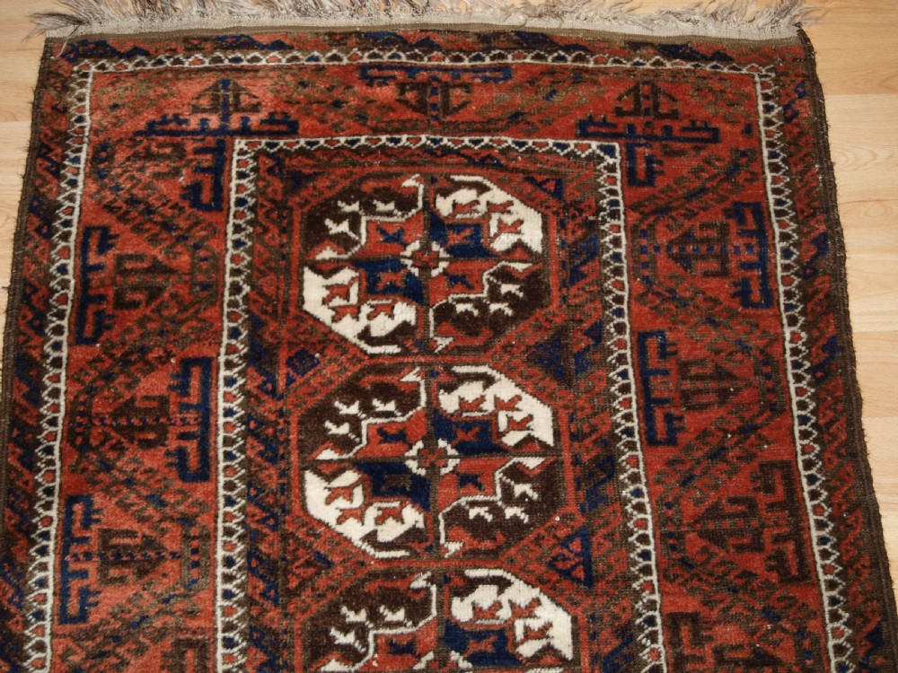 ANTIQUE MAHDAD KHANI BALUCH RUG, LARGE TURKMEN GULS, CIRCA 1900. View IV