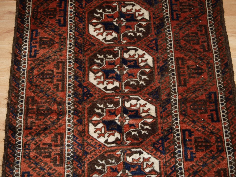 ANTIQUE MAHDAD KHANI BALUCH RUG, LARGE TURKMEN GULS, CIRCA 1900. View V