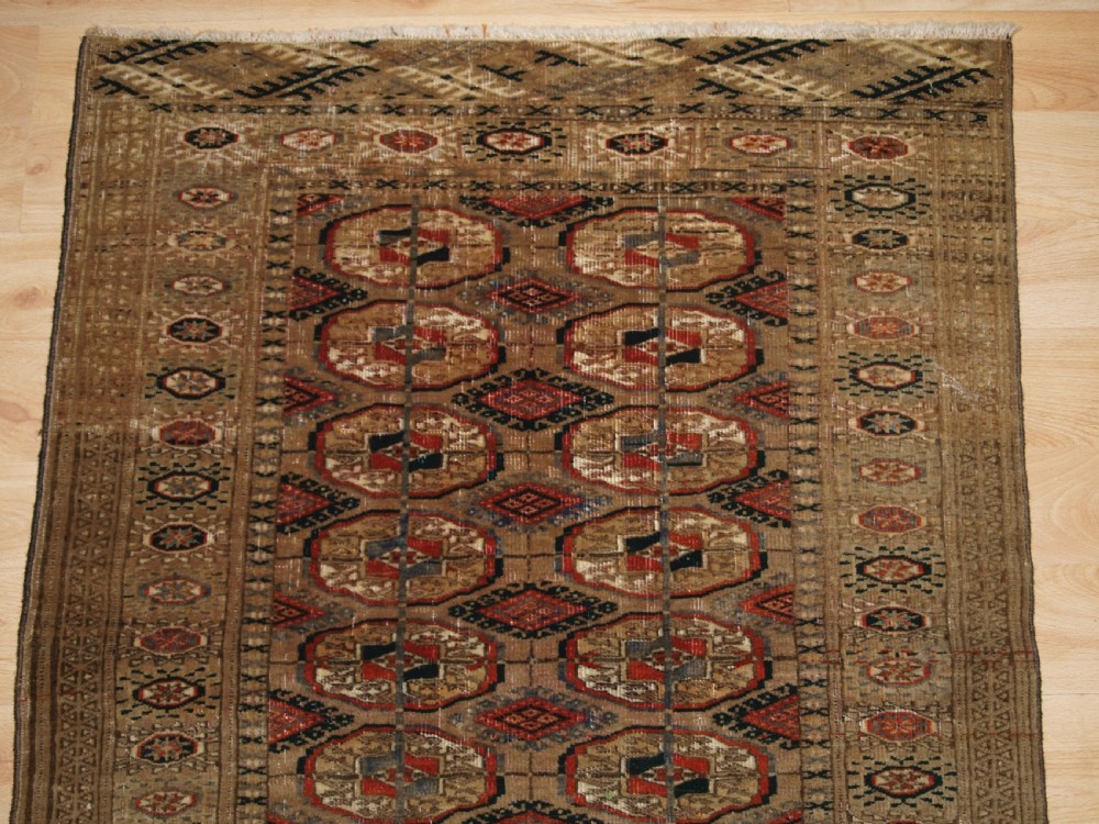 ANTIQUE TEKKE TURKMEN RUG WITH FADED COLOURS, CIRCA 1900. View III