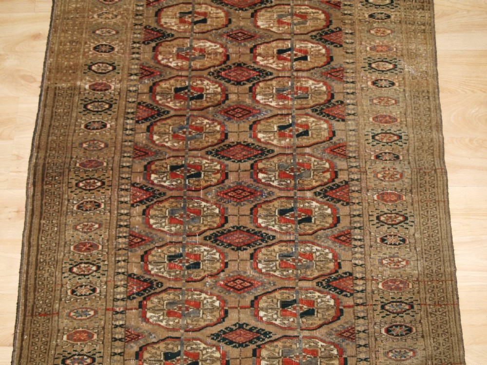 ANTIQUE TEKKE TURKMEN RUG WITH FADED COLOURS, CIRCA 1900. View IV
