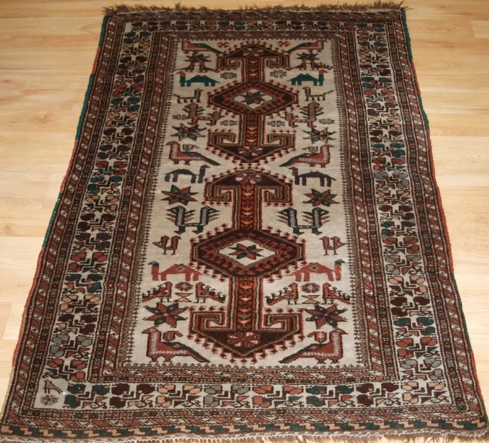 OLD KURDISH VILLAGE RUG, HOOKED MEDALLIONS WITH ANIMALS, CIRCA 1920.
