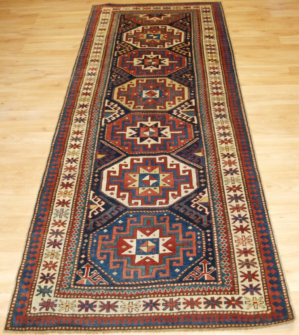ANTIQUE CAUCASIAN MOGHAN KAZAK RUNNER WITH MEMLING GUL DESIGN, CIRCA 1880.