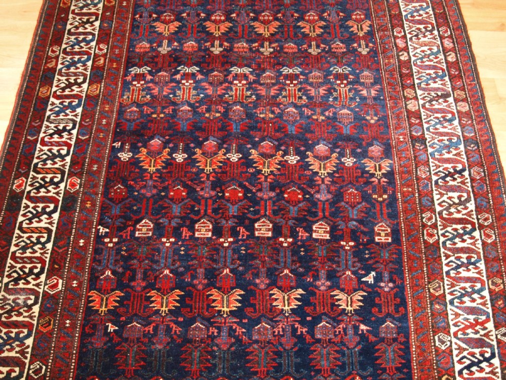 An antique hand-knotted Kurdish Kelleh long rug featuring a deep navy central field with geometric motifs enclosed by an ivory dragon pattern border. View V