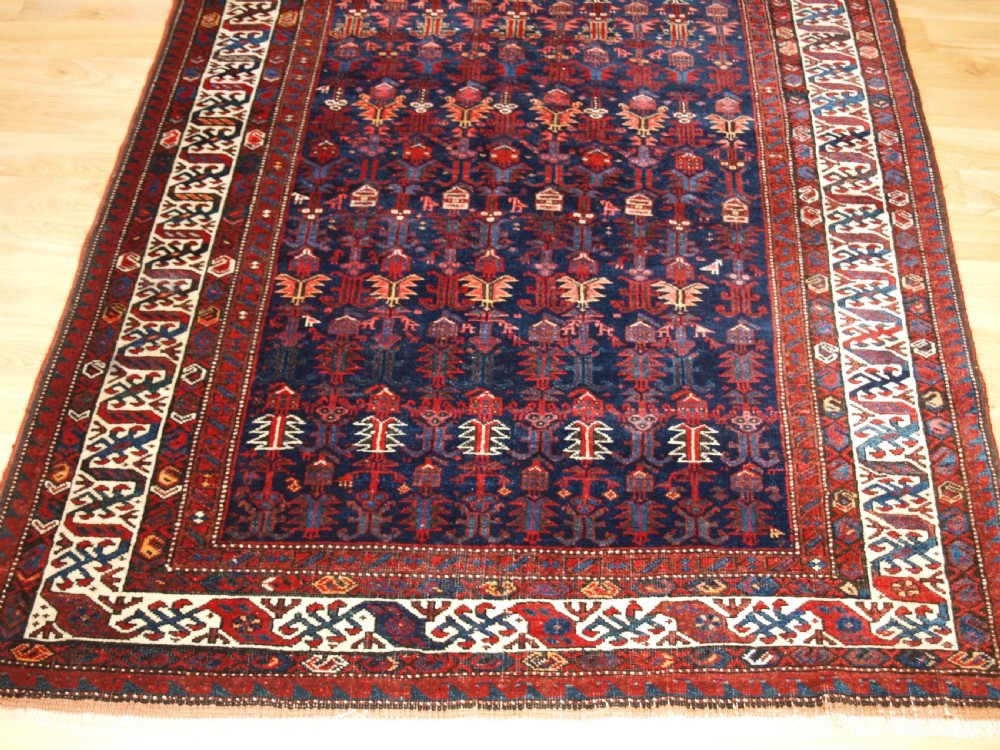 An antique hand-knotted Kurdish Kelleh long rug featuring a deep navy central field with geometric motifs enclosed by an ivory dragon pattern border. View VI