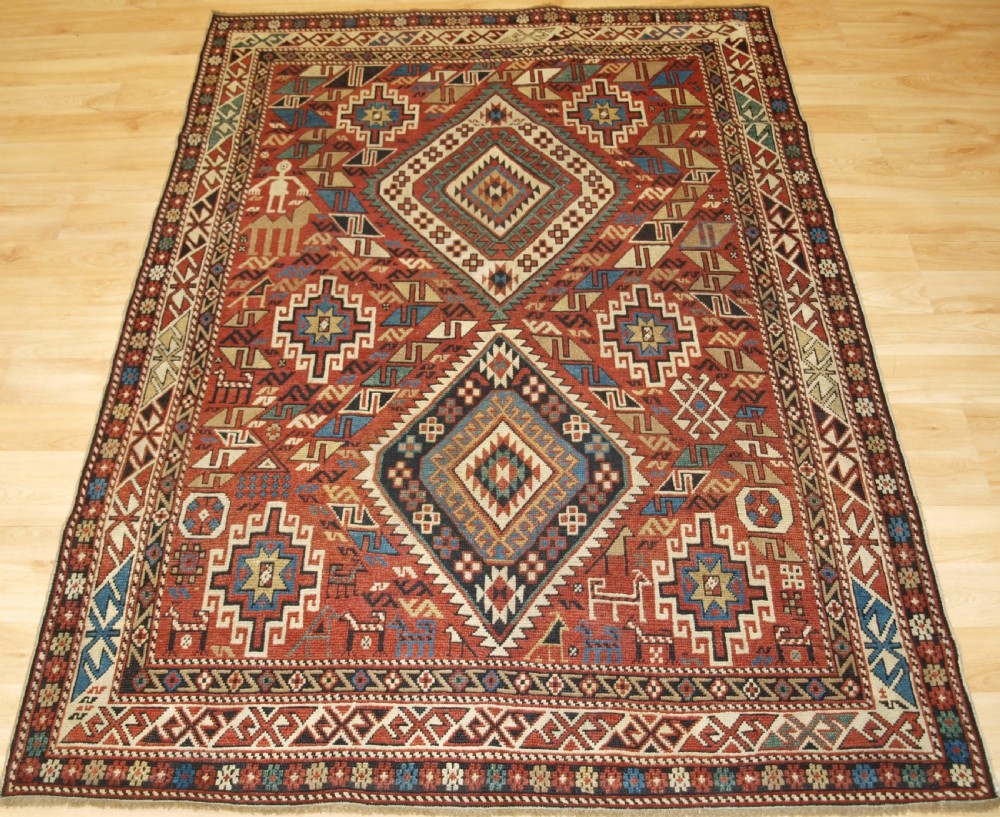ANTIQUE CAUCASIAN DAGHESTAN RUG, CAMEL, PEOPLE AND ANIMALS, CIRCA 1890