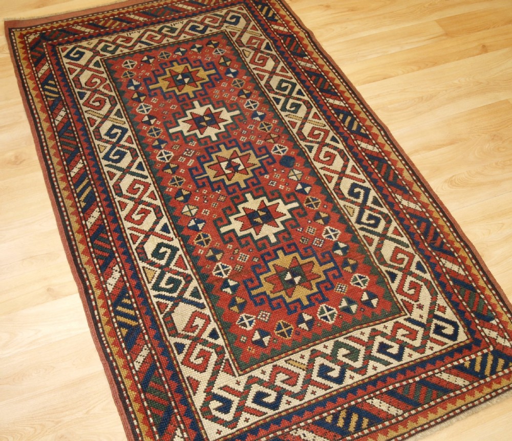 ANTIQUE CAUCASIAN KAZAK RUG WITH MEMLINC GULS, SMALL SIZE, CIRCA 1900. View II