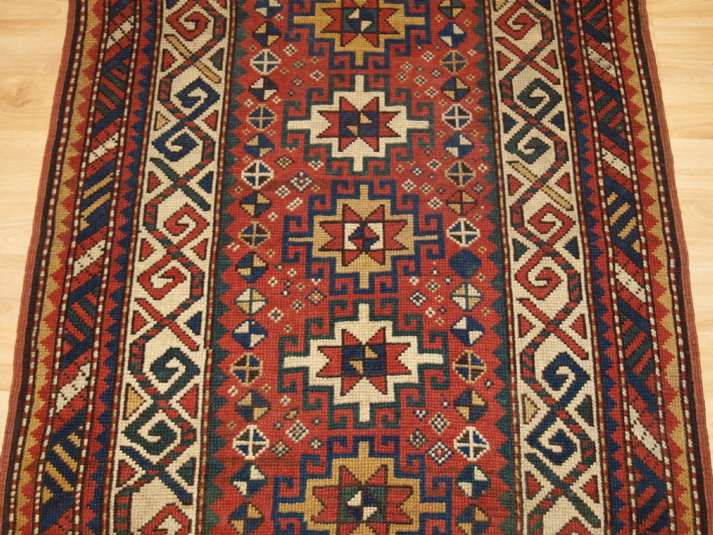 ANTIQUE CAUCASIAN KAZAK RUG WITH MEMLINC GULS, SMALL SIZE, CIRCA 1900. View V
