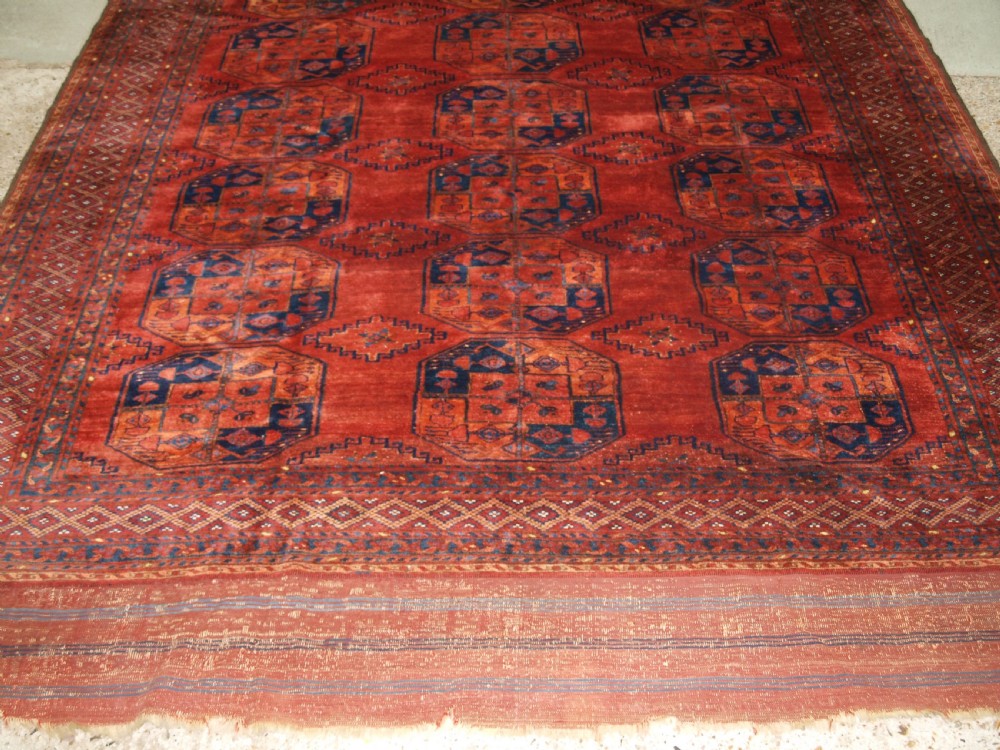 A large hand-knotted antique Ersari Turkmen carpet featuring octagonal gul motifs on a terracotta red wool field. View VI