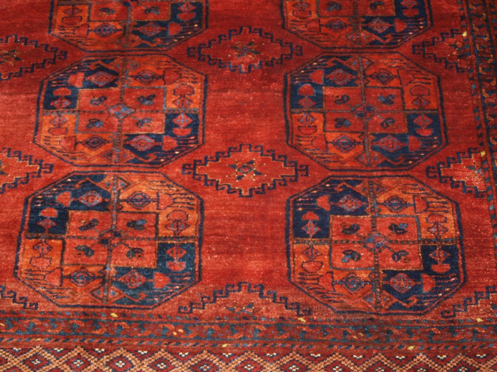 A large hand-knotted antique Ersari Turkmen carpet featuring octagonal gul motifs on a terracotta red wool field. View XI