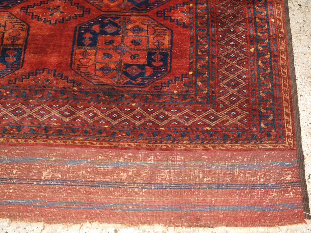 A large hand-knotted antique Ersari Turkmen carpet featuring octagonal gul motifs on a terracotta red wool field. View XIII