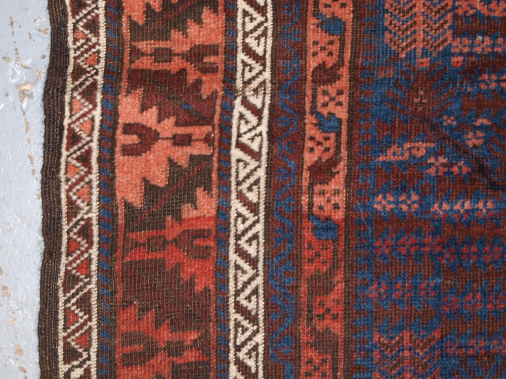 ANTIQUE TIMURI BALUCH RUG WITH BLUE GROUND AND TREE OF LIFE, CIRCA 1880. View VIII