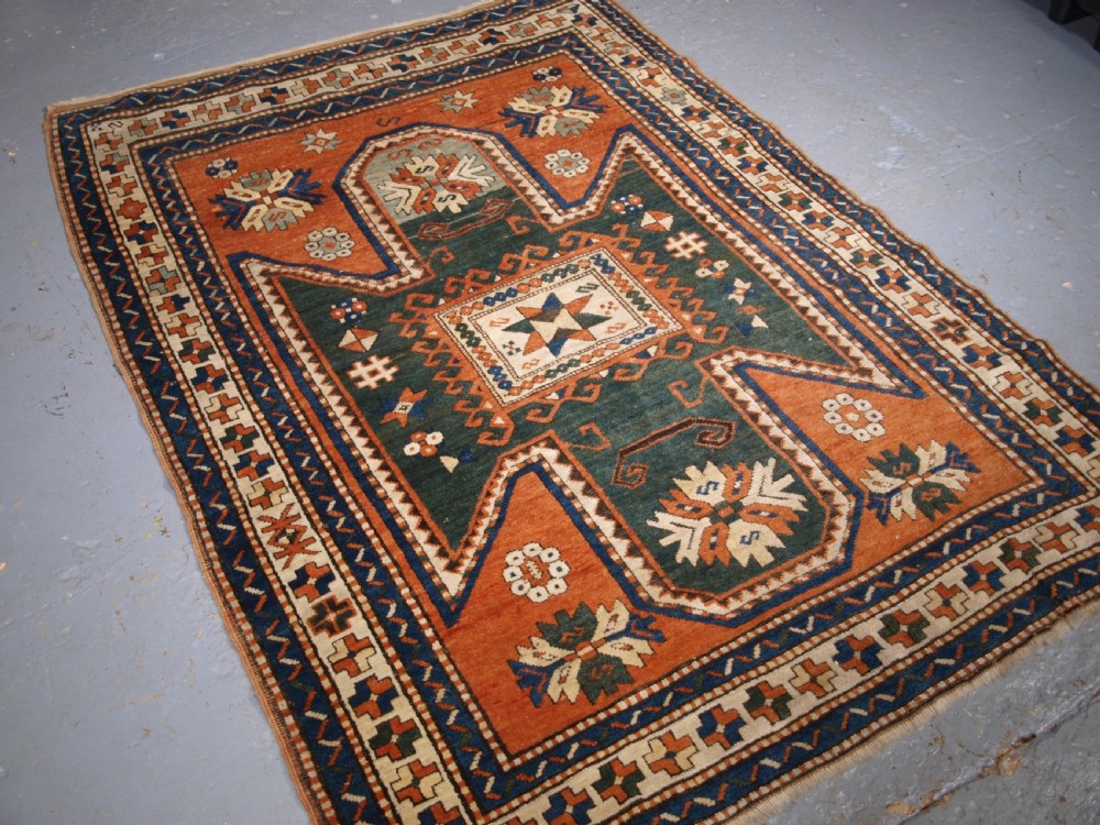 ANTIQUE CAUCASIAN SEWAN KAZAK RUG WITH GREEN GROUND MEDALLION, CIRCA 1890. View II