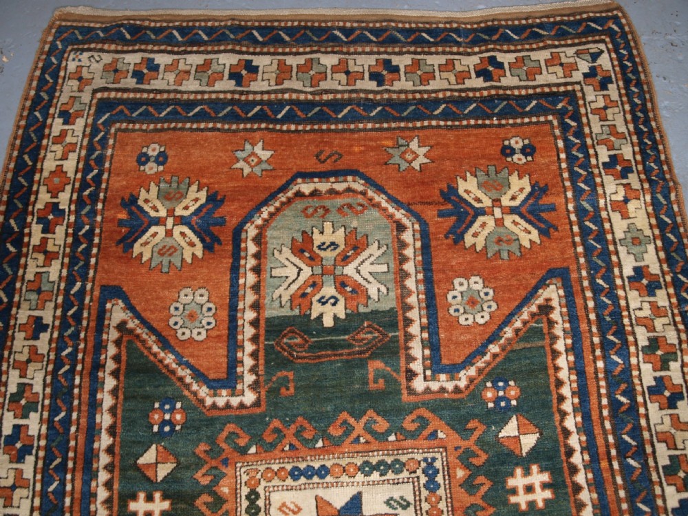 ANTIQUE CAUCASIAN SEWAN KAZAK RUG WITH GREEN GROUND MEDALLION, CIRCA 1890. View III