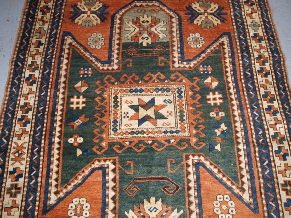 ANTIQUE CAUCASIAN SEWAN KAZAK RUG WITH GREEN GROUND MEDALLION, CIRCA 1890. View IV