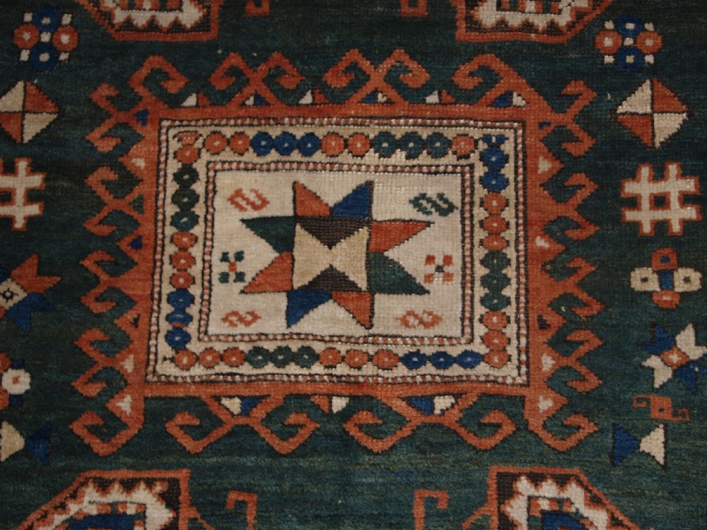 ANTIQUE CAUCASIAN SEWAN KAZAK RUG WITH GREEN GROUND MEDALLION, CIRCA 1890. View IX
