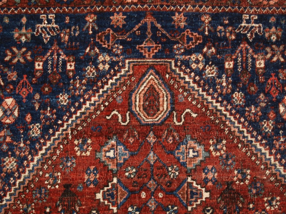 An antique hand-knotted Persian Abedeh rug featuring a central cream diamond medallion surrounded by a terracotta red field with navy blue corners. View VIII