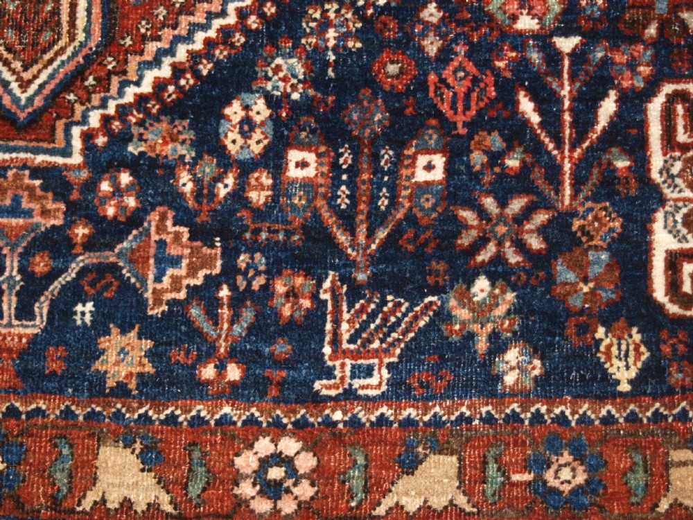 An antique hand-knotted Persian Abedeh rug featuring a central cream diamond medallion surrounded by a terracotta red field with navy blue corners. View IX