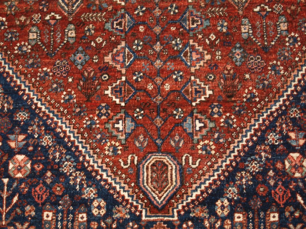 An antique hand-knotted Persian Abedeh rug featuring a central cream diamond medallion surrounded by a terracotta red field with navy blue corners. View X