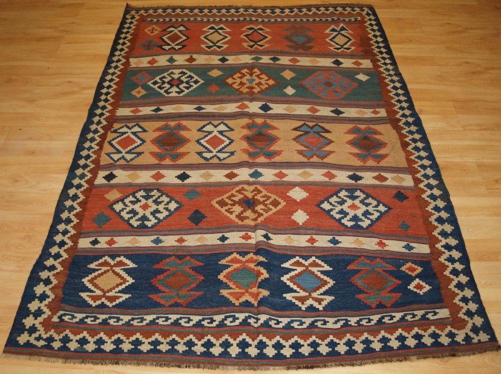 ANTIQUE QASHQAI TRIBAL KILIM WITH BANDED DESIGN, CIRCA 1900.