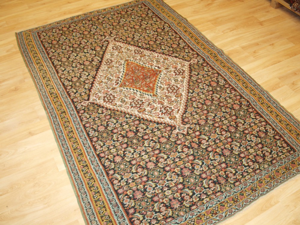 ANTIQUE SENNEH KILIM, SINGLE MEDALLION WITH HERATI, CIRCA 1900. View II