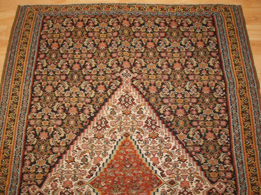 ANTIQUE SENNEH KILIM, SINGLE MEDALLION WITH HERATI, CIRCA 1900. View IV