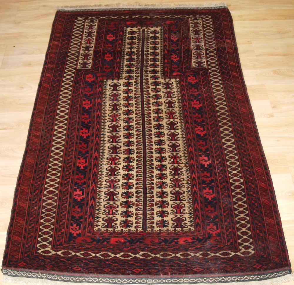 OLD BALUCH CAMEL GROUND PRAYER RUG WITH TREE OF LIFE, CIRCA 1920.
