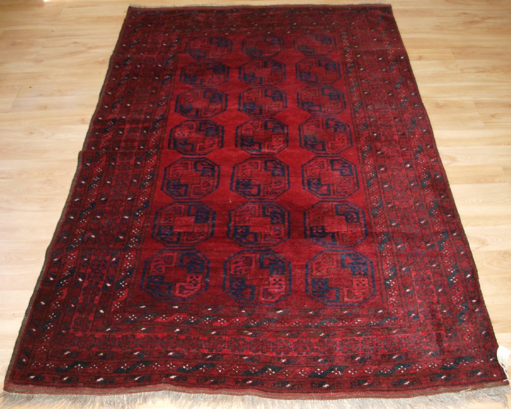 OLD AFGHAN VILLAGE RUG OF TRADITIONAL DESIGN, GOOD COLOUR, CIRCA 1920.