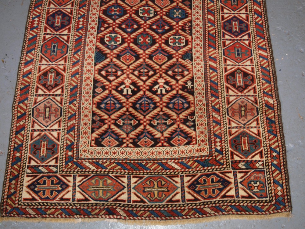 ANTIQUE CAUCASIAN DAGESTAN RUG, LATTICE DESIGN WITH HUMAN FIGURES, CIRCA 1880. View V