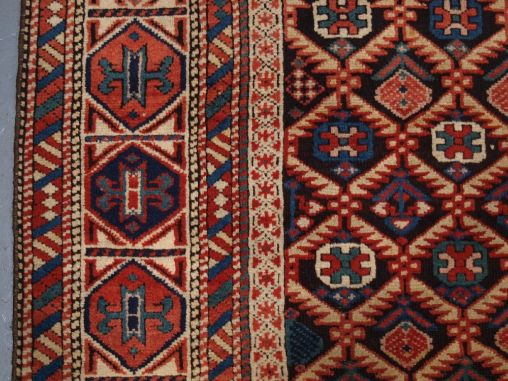 ANTIQUE CAUCASIAN DAGESTAN RUG, LATTICE DESIGN WITH HUMAN FIGURES, CIRCA 1880. View VII