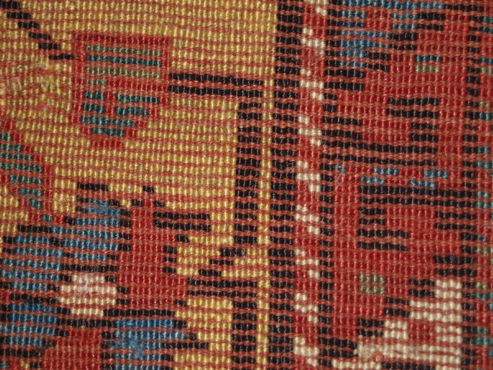 An antique South Caucasian Karabagh long rug featuring five large geometric medallions down a red central field framed by yellow floral and geometric borders. View XIV