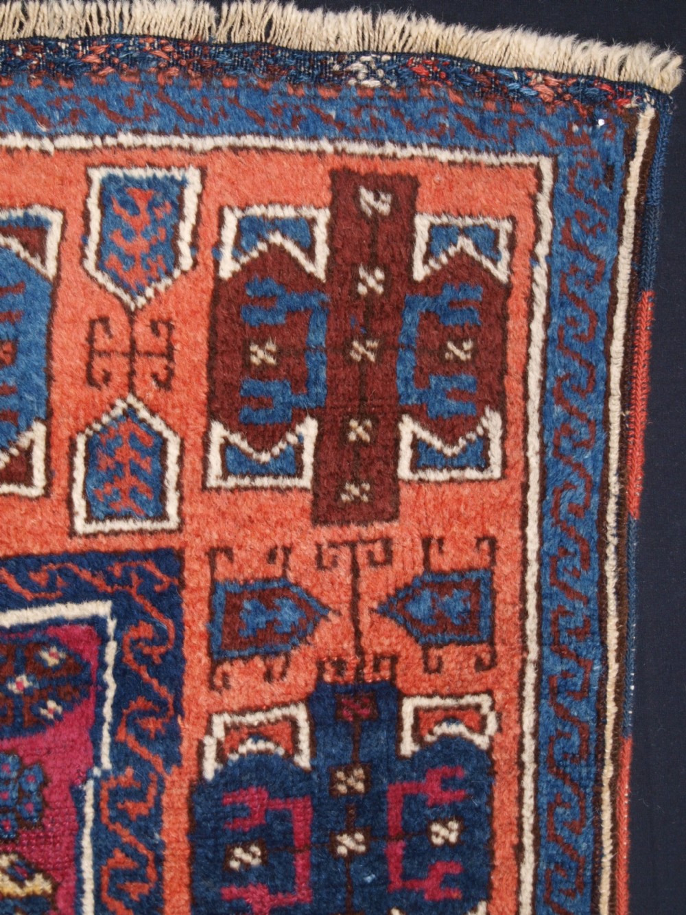 An antique East Anatolian Yuruk hand-knotted wool prayer rug featuring a blue central arched niche surrounded by magenta and terracotta geometric borders. View VI