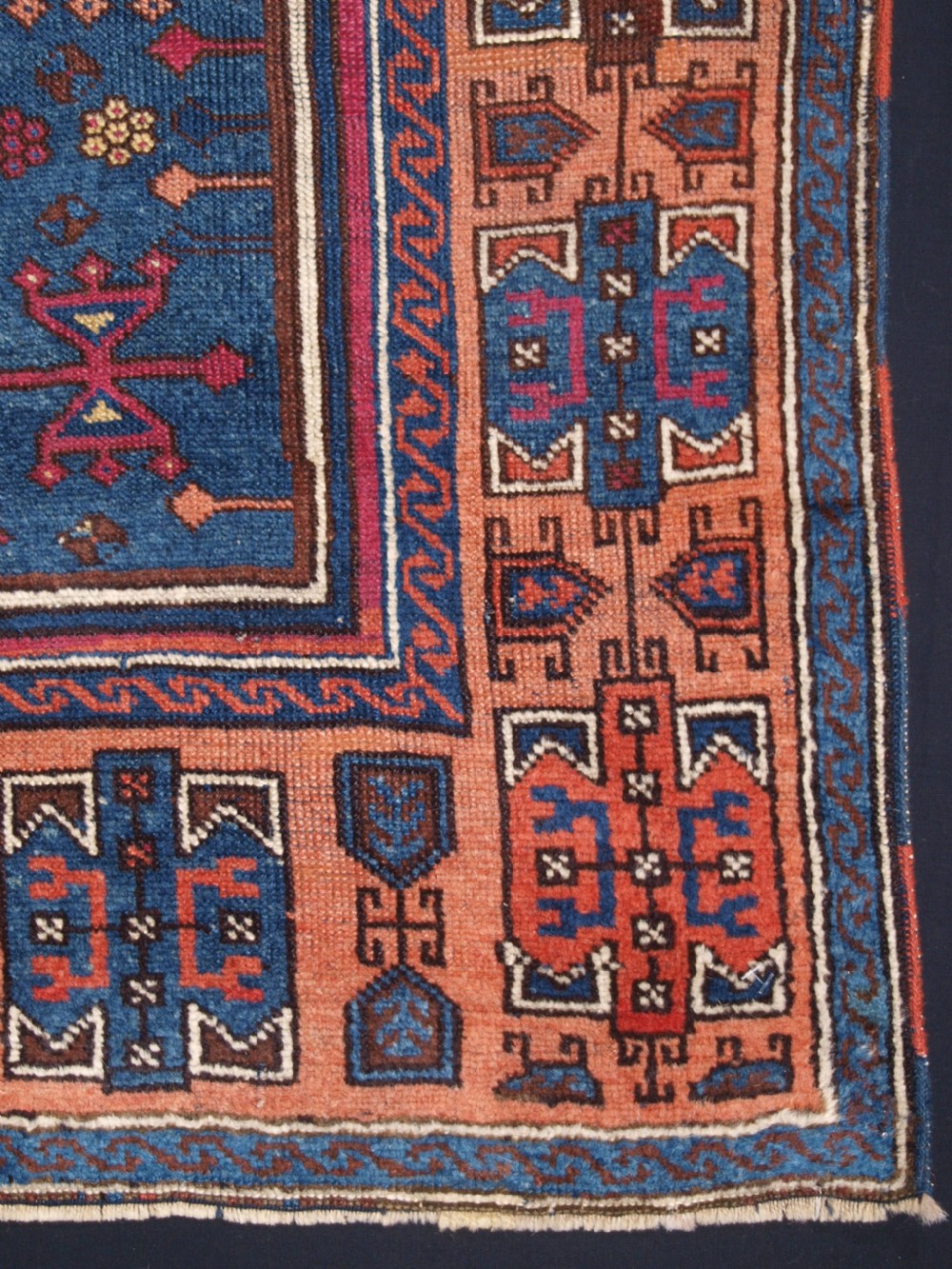 An antique East Anatolian Yuruk hand-knotted wool prayer rug featuring a blue central arched niche surrounded by magenta and terracotta geometric borders. View IX