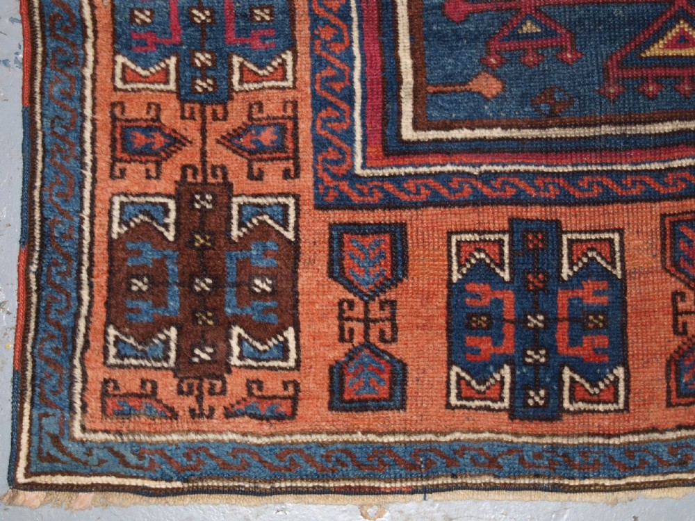 An antique East Anatolian Yuruk hand-knotted wool prayer rug featuring a blue central arched niche surrounded by magenta and terracotta geometric borders. View XI