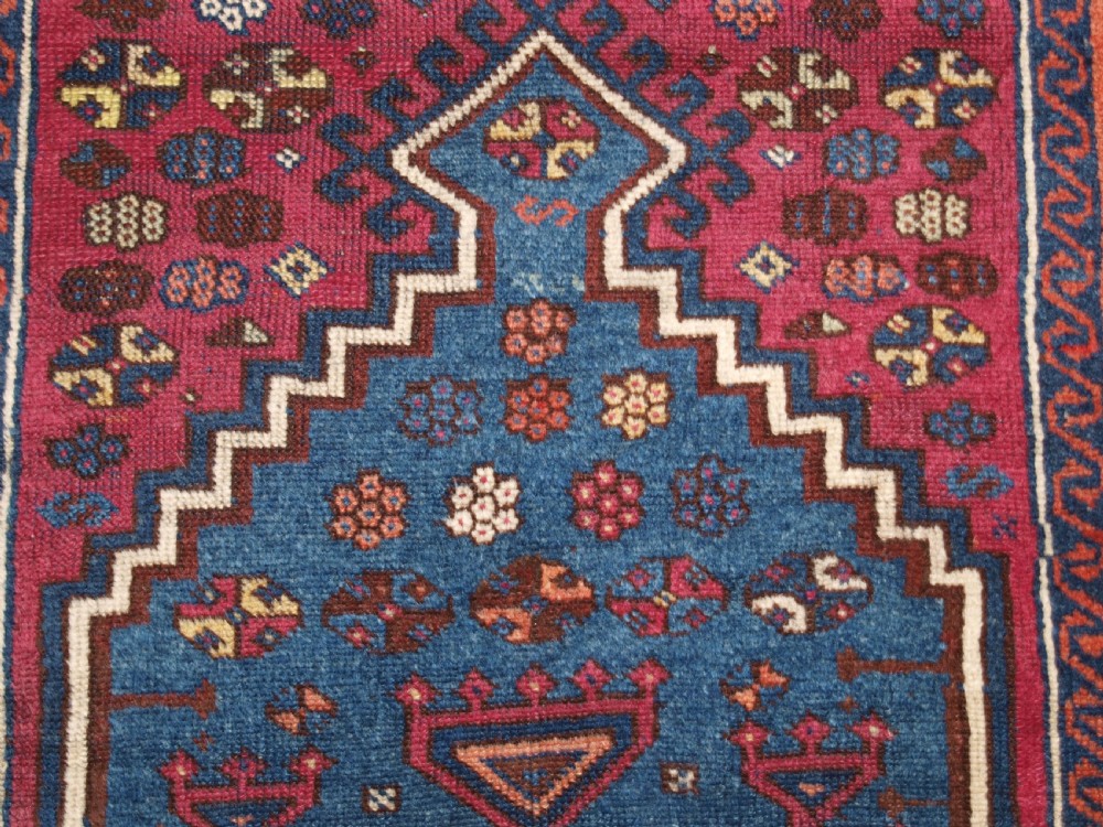 An antique East Anatolian Yuruk hand-knotted wool prayer rug featuring a blue central arched niche surrounded by magenta and terracotta geometric borders. View XII