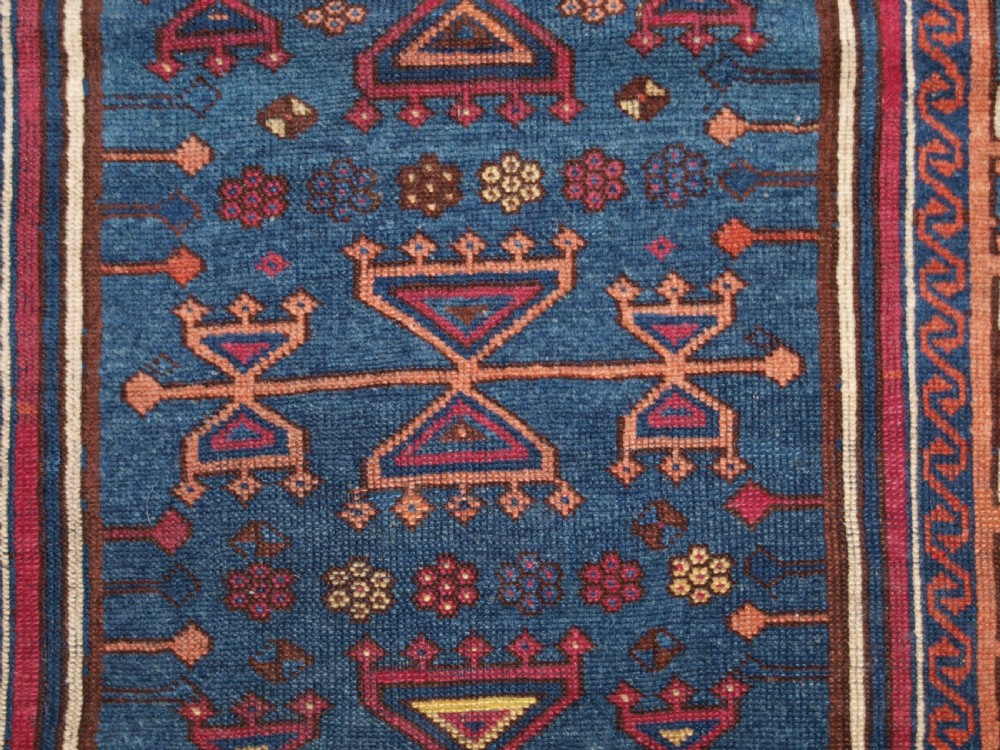 An antique East Anatolian Yuruk hand-knotted wool prayer rug featuring a blue central arched niche surrounded by magenta and terracotta geometric borders. View XIII
