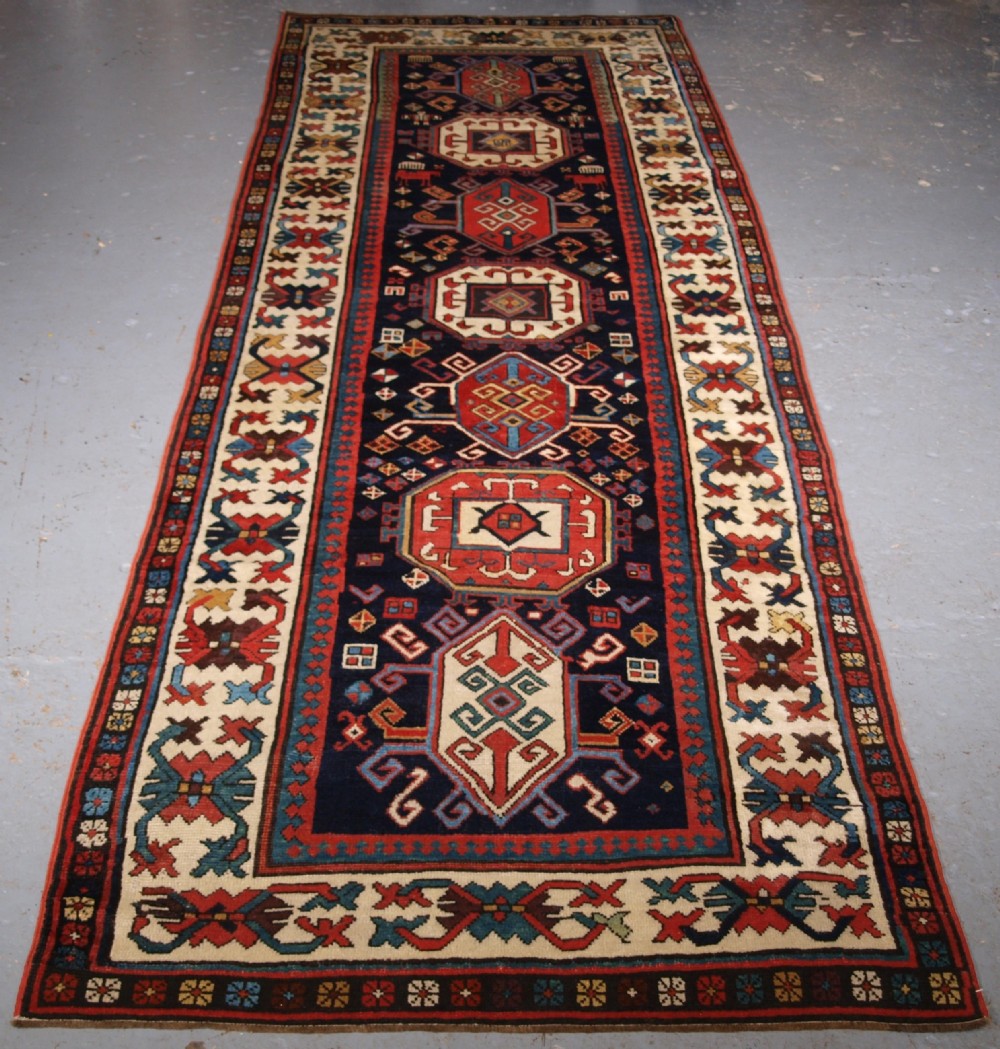 ANTIQUE CAUCASIAN GENDJE KAZAK RUNNER WITH MEDALLION DESIGN, CIRCA 1890.