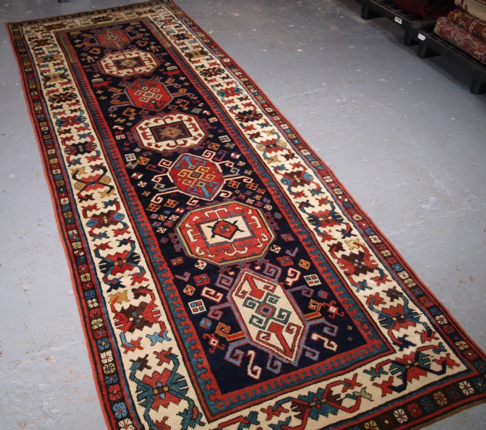 ANTIQUE CAUCASIAN GENDJE KAZAK RUNNER WITH MEDALLION DESIGN, CIRCA 1890. View II
