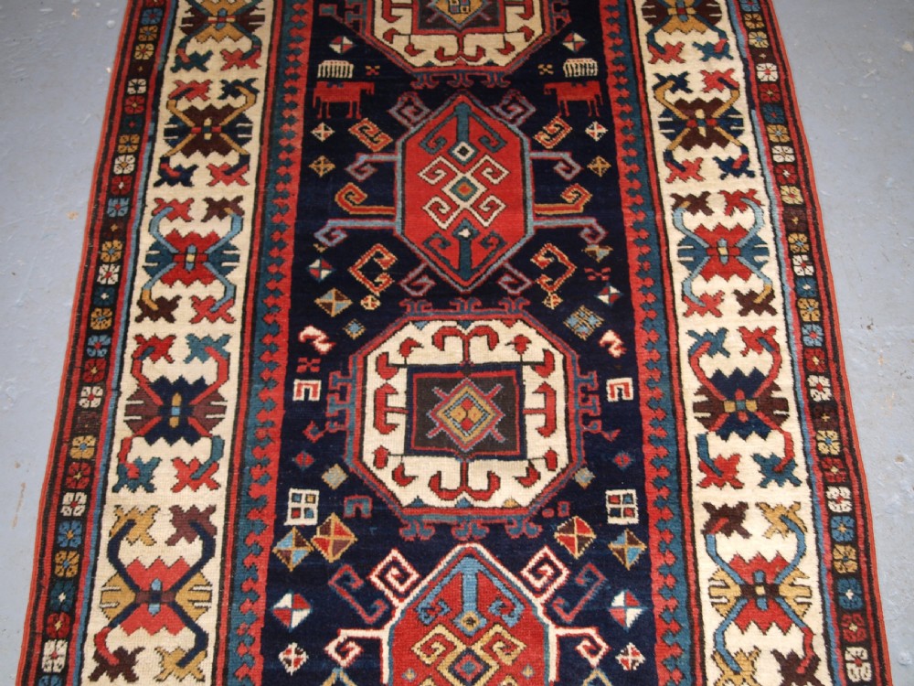ANTIQUE CAUCASIAN GENDJE KAZAK RUNNER WITH MEDALLION DESIGN, CIRCA 1890. View IV