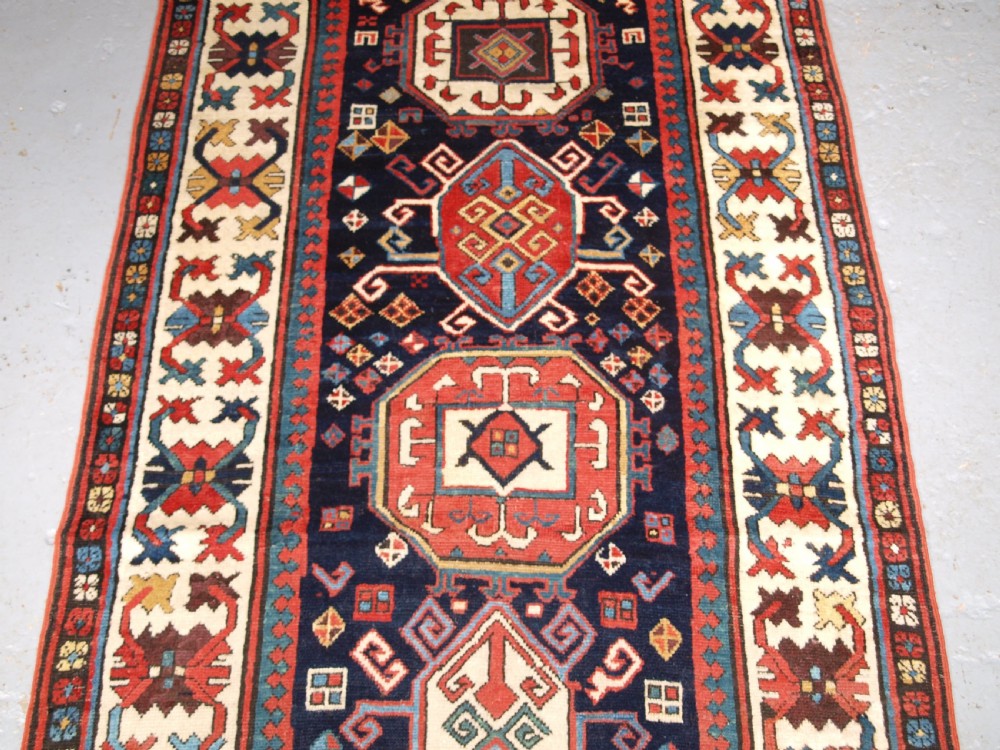 ANTIQUE CAUCASIAN GENDJE KAZAK RUNNER WITH MEDALLION DESIGN, CIRCA 1890. View V