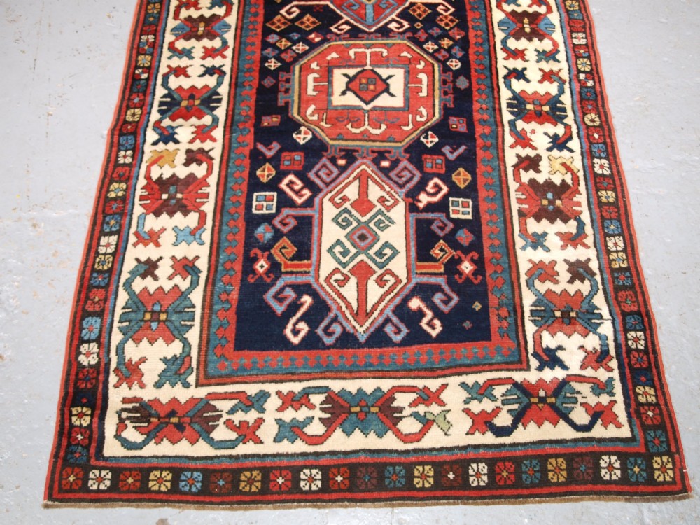 ANTIQUE CAUCASIAN GENDJE KAZAK RUNNER WITH MEDALLION DESIGN, CIRCA 1890. View VI