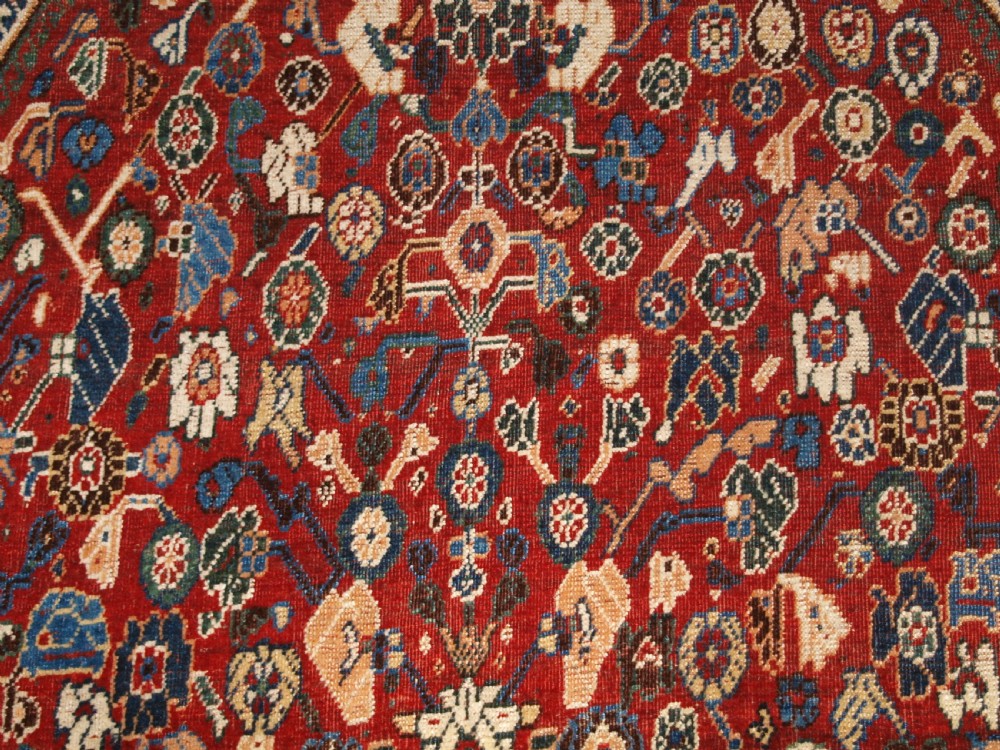 An antique hand-knotted Qashqai Kashkuli wool rug featuring a central red diamond medallion framed by complex floral motifs and multi-band geometric borders. View XI
